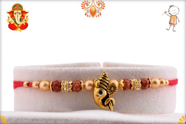 Divine Ganesh Rakhi with Golden Beads and Diamonds | Send Rakhi Gifts Online